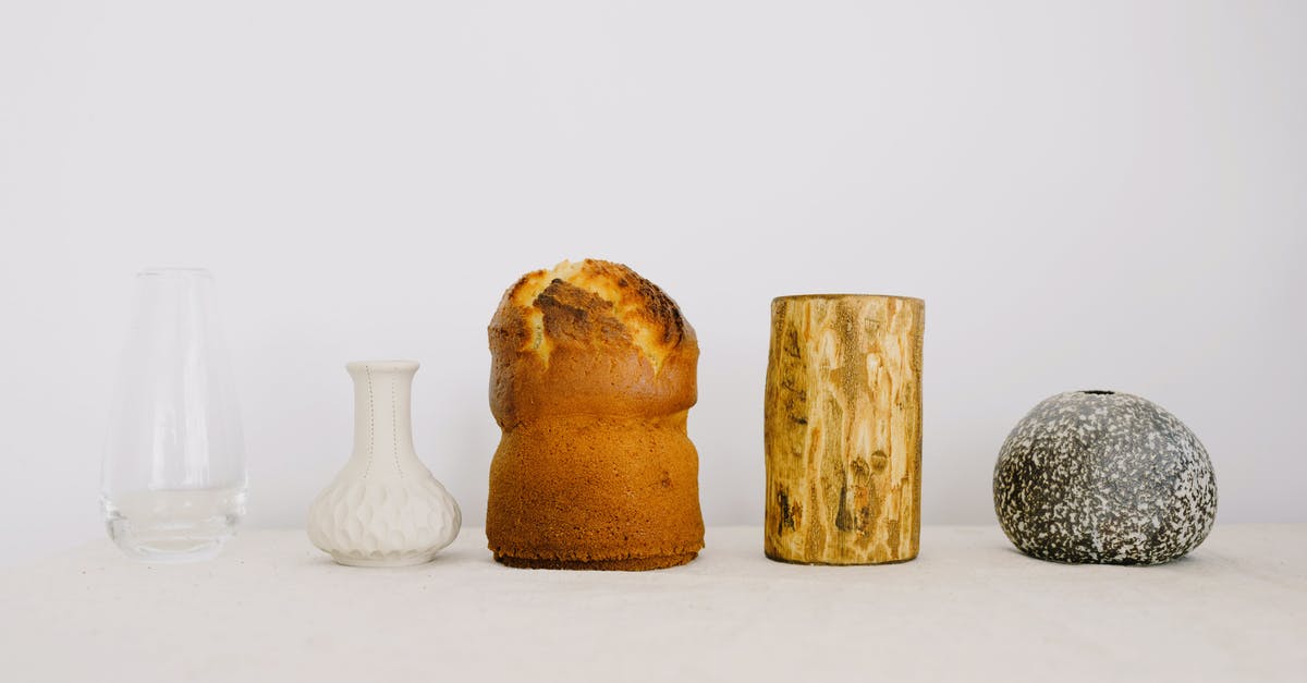 Does oven spring differ between white and sourdough breads? - Traditional Easter cake with wood chock and various vases placed on white table against white wall as symbol of traditional Easter holiday