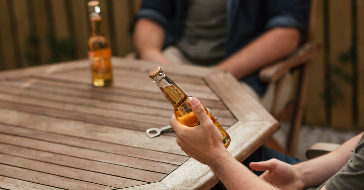 Does sauteing onions produce alcohol or something similar to alcohol? - Crop anonymous male partners with glass bottles of alcoholic drink sitting at wooden table on weekend Does sauteing onions produce alcohol or something similar to alcohol? - Crop anonymous male partners with glass bottles of alcoholic drink sitting at wooden table on weekend