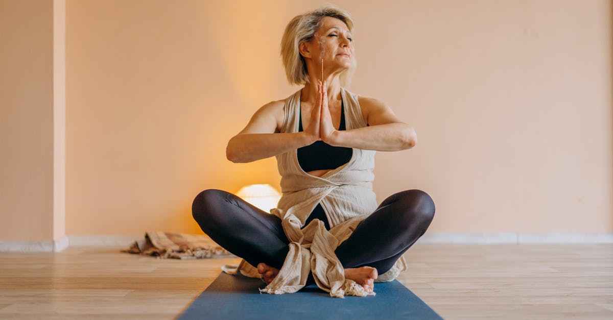 Does the direction matter in the Stretch and Fold method? - Full body of middle aged lady in activewear sitting on mat in lotus position in light room with closed eyes Does the direction matter in the Stretch and Fold method? - Full body of middle aged lady in activewear sitting on mat in lotus position in light room with closed eyes