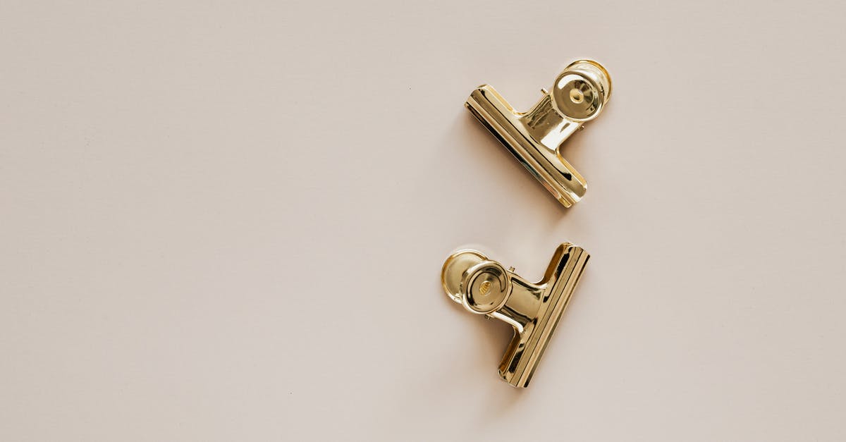 Does the size of chilli pieces affect the hotness - Golden metal clips on beige background Does the size of chilli pieces affect the hotness - Golden metal clips on beige background