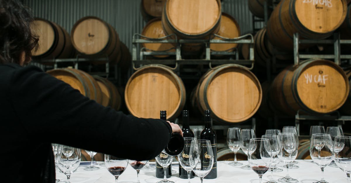 Does the vendors’ storage method affect shellfish quality? - Back view of anonymous sommelier pouring wine from bottle into wineglass while standing at table with glassware in winery against barrels Does the vendors’ storage method affect shellfish quality? - Back view of anonymous sommelier pouring wine from bottle into wineglass while standing at table with glassware in winery against barrels