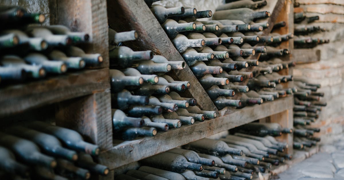 Does the vendors’ storage method affect shellfish quality? - Dusty alcoholic beverage bottles with coiled corks on wooden shelves at wine farm Does the vendors’ storage method affect shellfish quality? - Dusty alcoholic beverage bottles with coiled corks on wooden shelves at wine farm