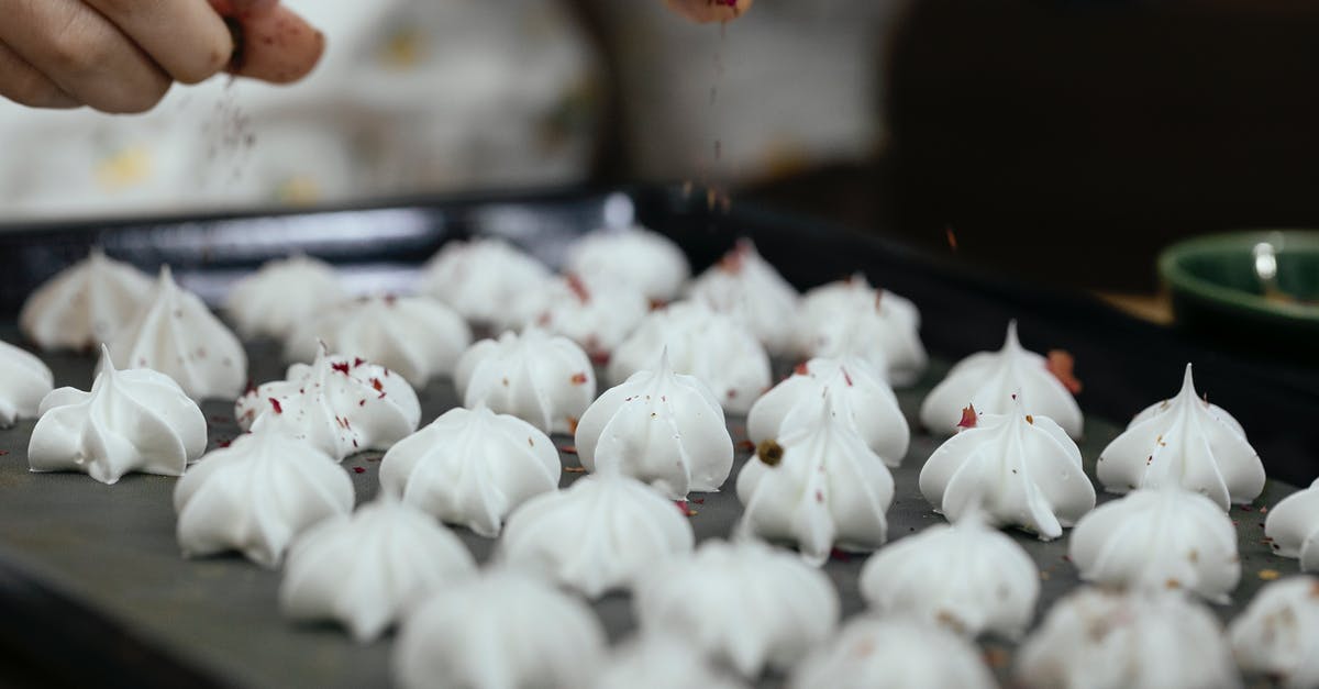 Does vanilla powder really prevent melted chocolate from seizing? - Crop faceless chef pouring chocolate powder on meringue cookies Does vanilla powder really prevent melted chocolate from seizing? - Crop faceless chef pouring chocolate powder on meringue cookies