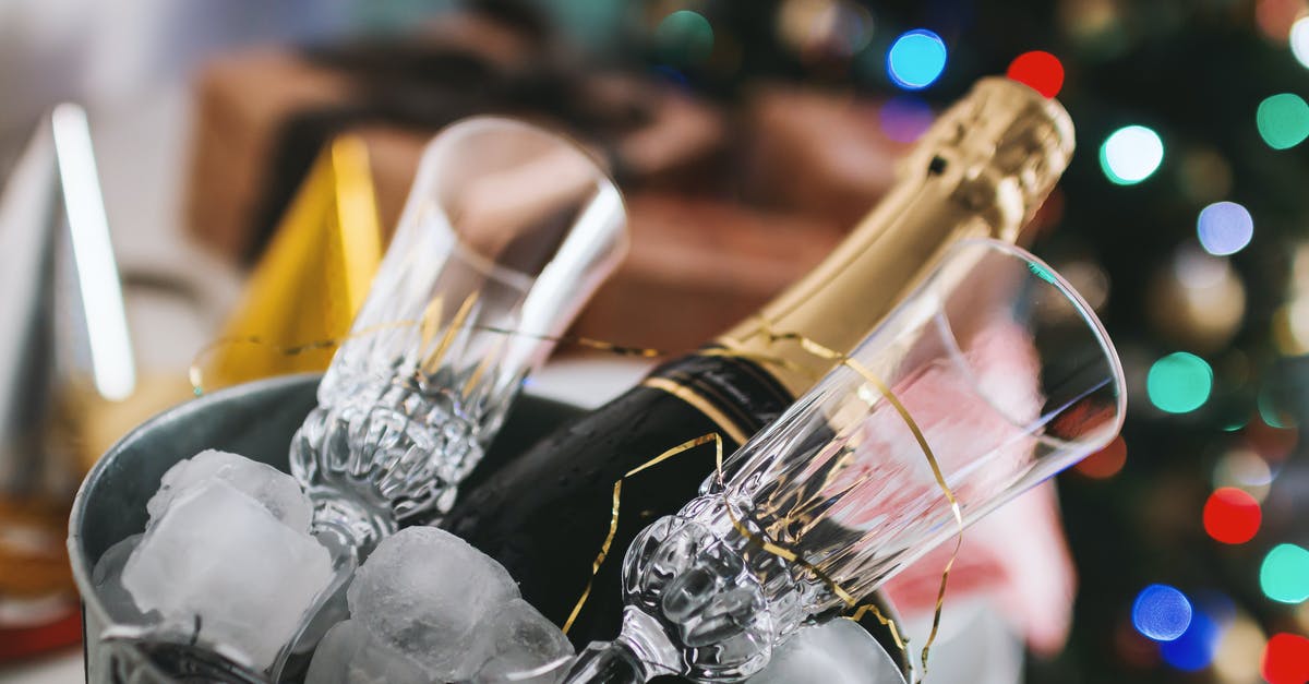 Donvier ice cream maker - inserting the bucket - Selective Focus Photography of Brown Labeled Bottle and Two Clear Glass Champagne Flutes