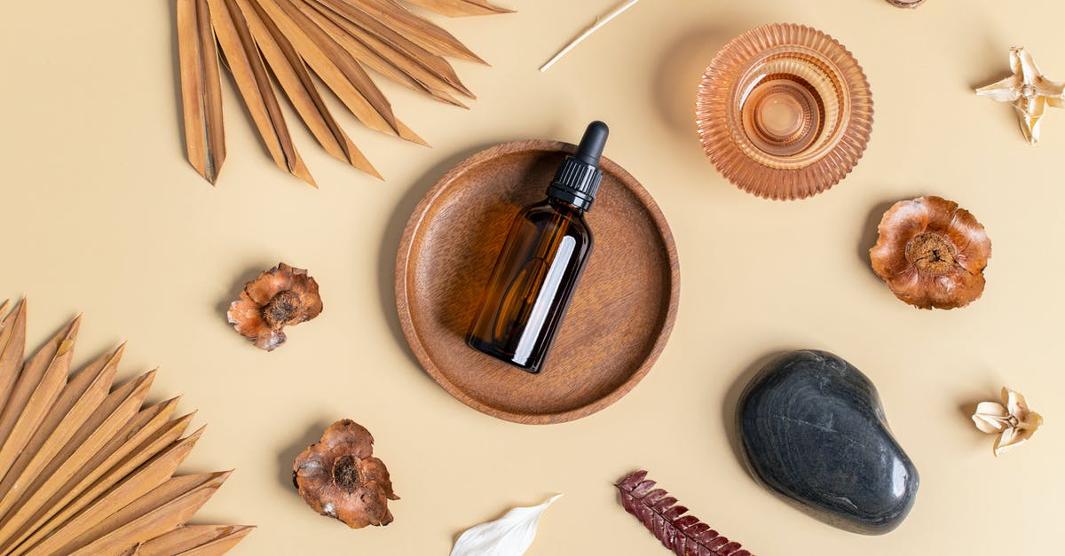 dry garlic in oil --> botulism risk? - Natural Oil in Brown Bottle Laying on Wooden Plate