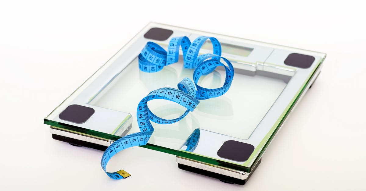Dry measurement and conversion to weight - Blue Tape Measuring on Clear Glass Square Weighing Scale Dry measurement and conversion to weight - Blue Tape Measuring on Clear Glass Square Weighing Scale