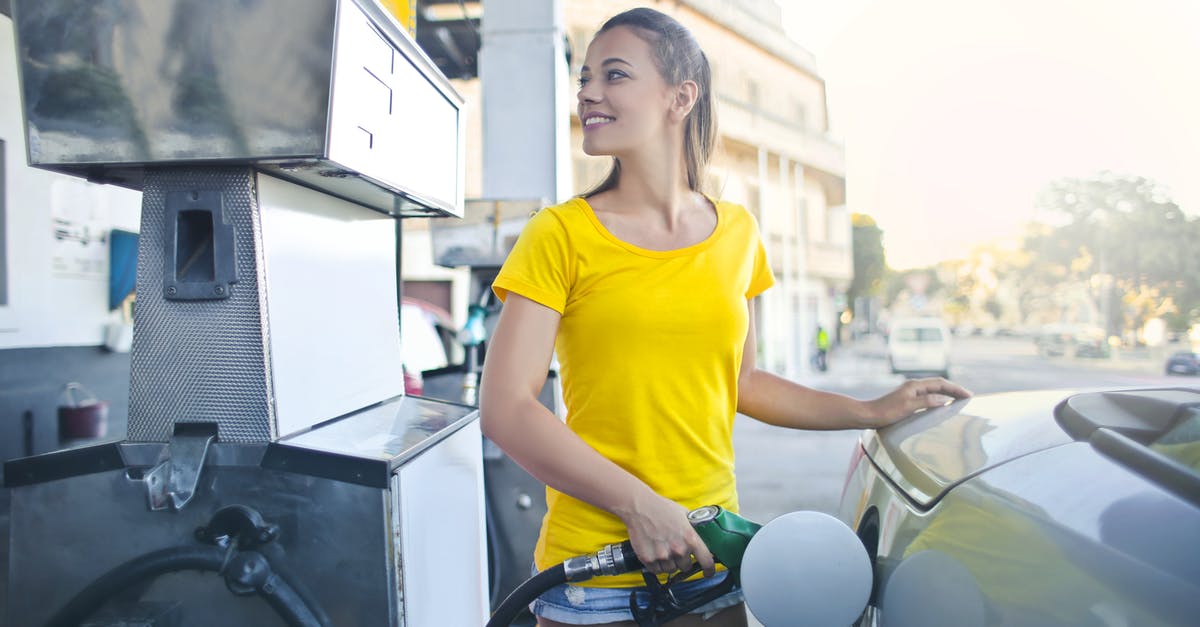 Dulce De leche as a macaron filling - Woman in Yellow Shirt While Filling Up Her Car With Gasoline Dulce De leche as a macaron filling - Woman in Yellow Shirt While Filling Up Her Car With Gasoline