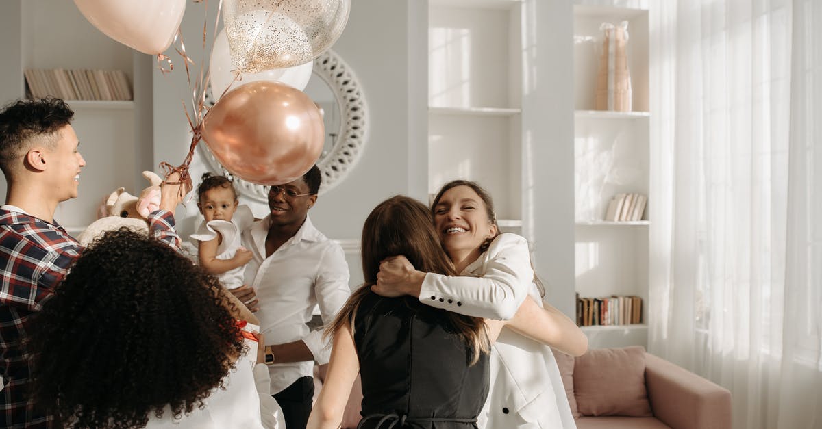Dying a white iced cake black - Women Hugging in the Birthday Party Celebration Dying a white iced cake black - Women Hugging in the Birthday Party Celebration