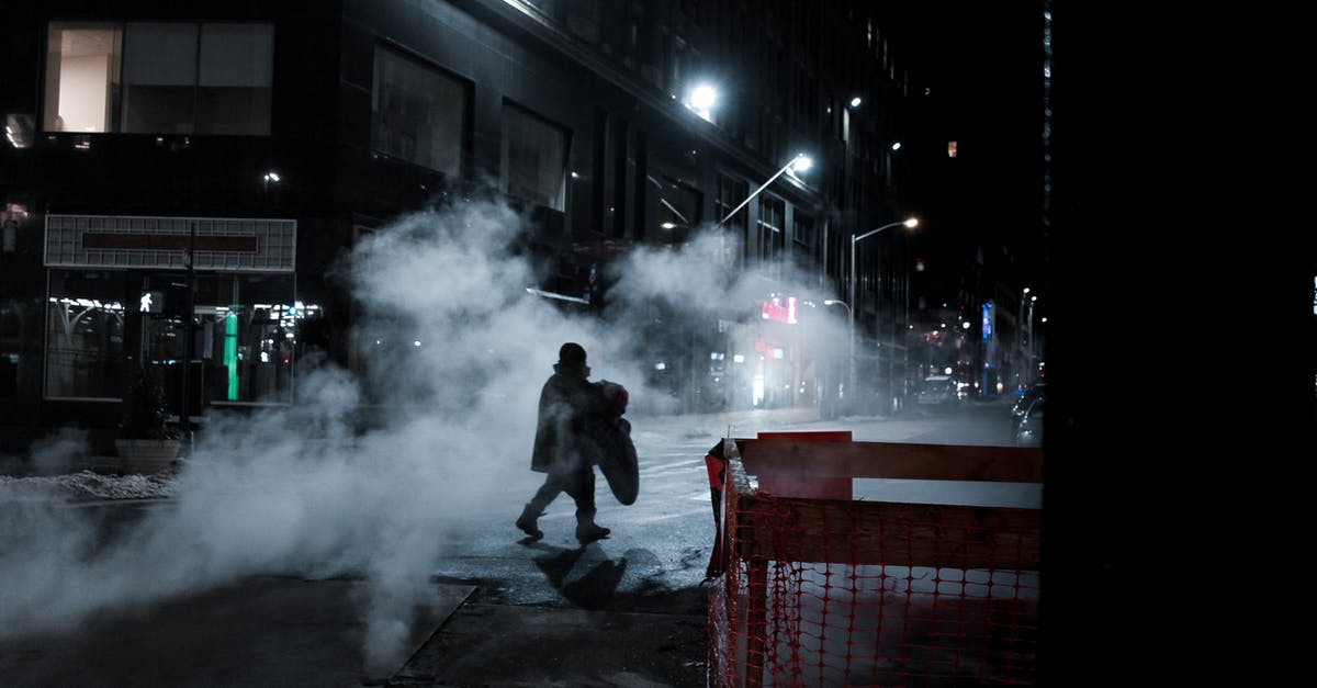 Easy way to steam vegetables in opened steam-in-bag kind - Side view of distant anonymous person crossing asphalt roadway on street with steam and residential buildings at night time in city Easy way to steam vegetables in opened steam-in-bag kind - Side view of distant anonymous person crossing asphalt roadway on street with steam and residential buildings at night time in city