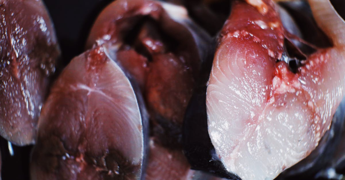 Eating dehydrated uncooked red potato - Raw fish placed in heap in daylight Eating dehydrated uncooked red potato - Raw fish placed in heap in daylight
