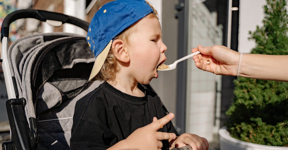 Eating food slightly past its prime [duplicate] - Woman in Black Crew Neck T-shirt and Blue Cap Holding Black Dslr Camera