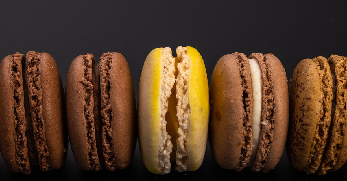 Edible Non Toxic Pencil Alternative for Baking Stencils? - Top view of yummy sweet macaroons with cream arranged in row on black background