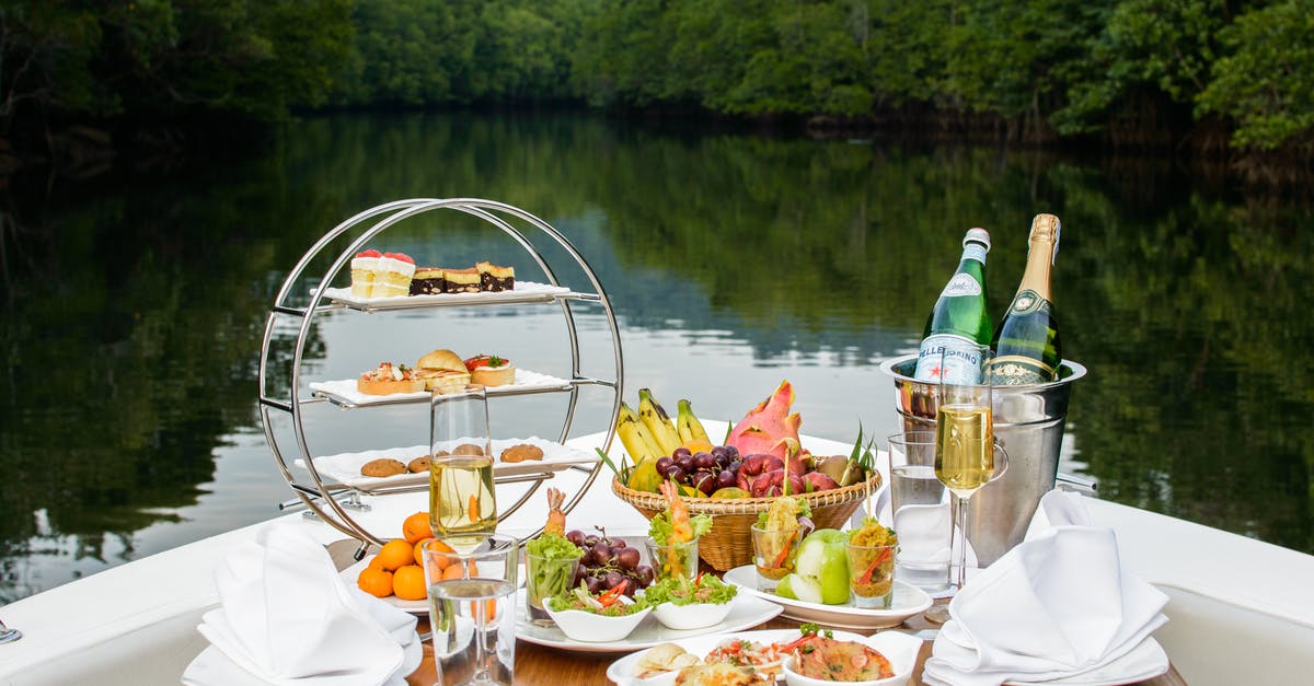 Effect of wine used for deglazing on dish - Food Photography of Food and Wine Bottles on Table Inside Boat Effect of wine used for deglazing on dish - Food Photography of Food and Wine Bottles on Table Inside Boat