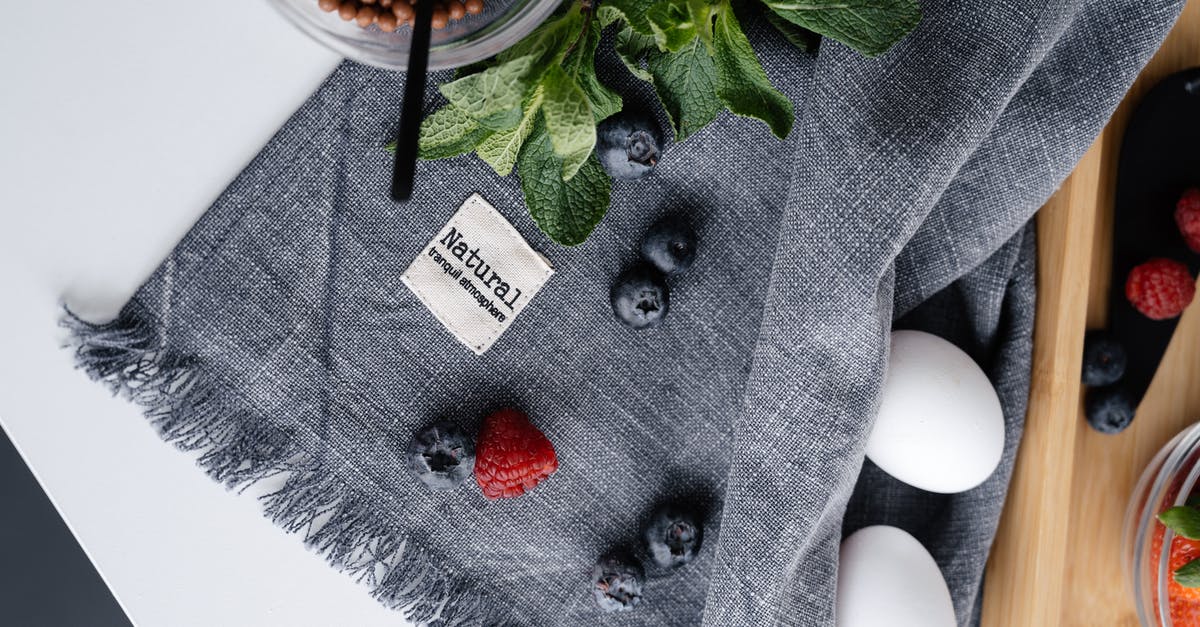Egg free steamed raspberry pudding - Fresh berries and eggs on crumpled fabric Egg free steamed raspberry pudding - Fresh berries and eggs on crumpled fabric