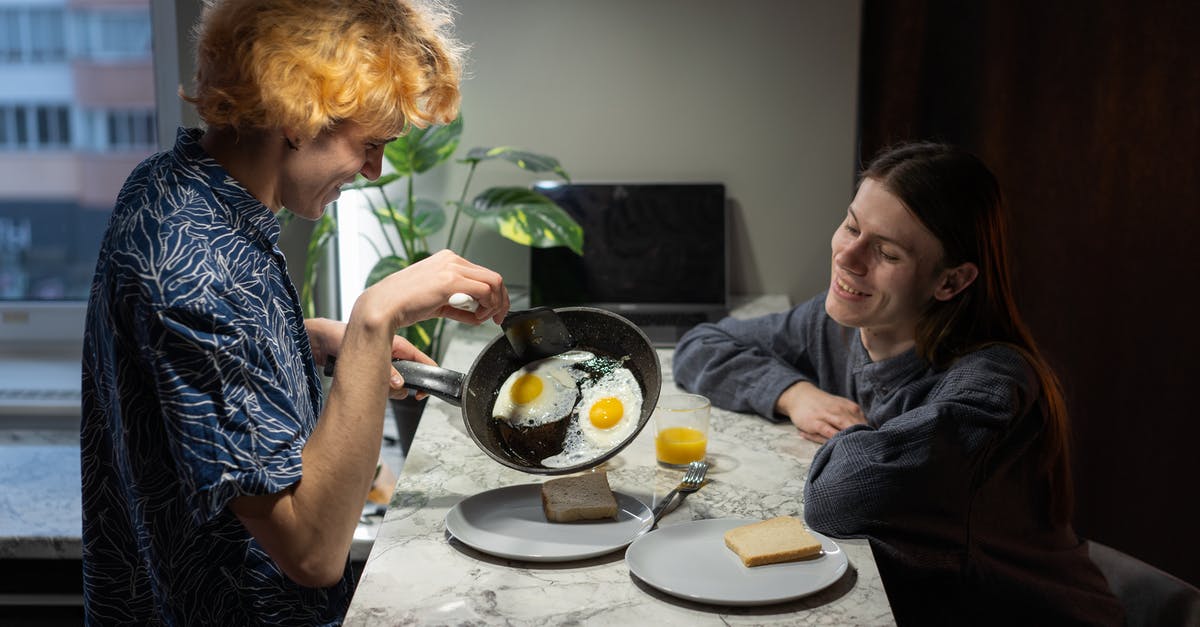 Eggs sticking to the pan - A Couple Having Breakfast Eggs sticking to the pan - A Couple Having Breakfast