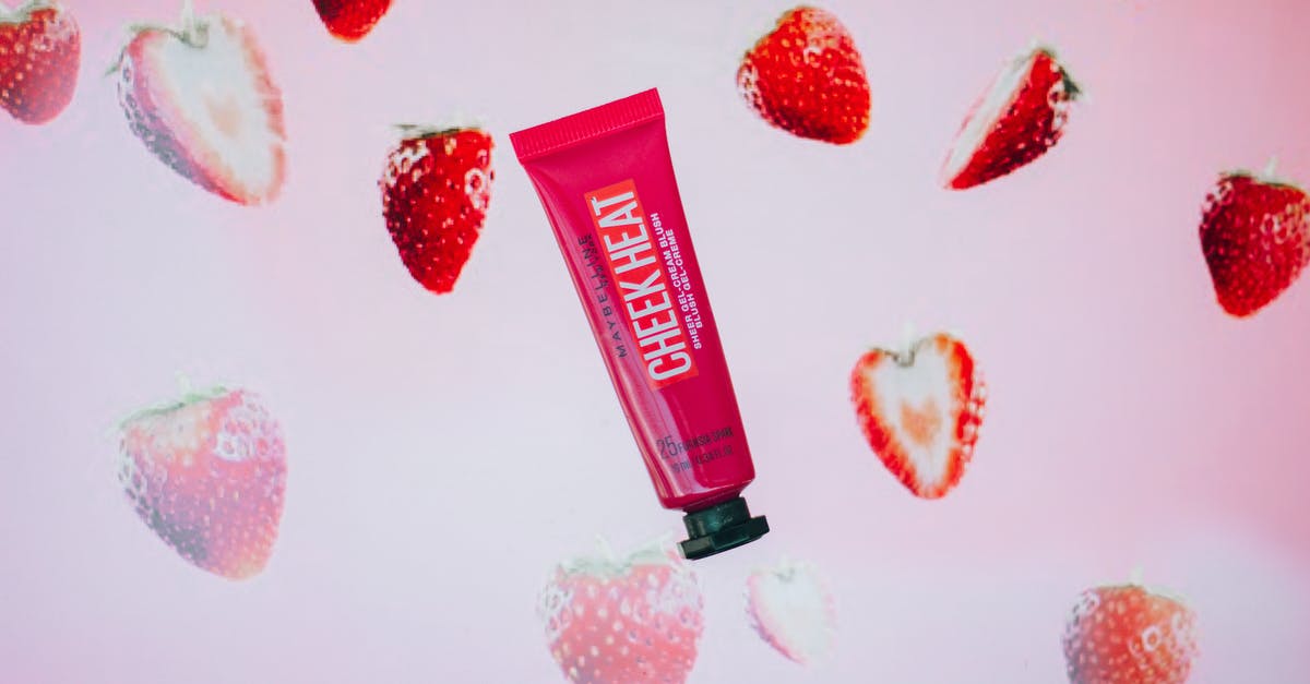 Emulating Starbucks Frappuccino Cream Base - Red tube with gel cream blush with strawberry flavor for daily beauty routine and makeup application placed on pink background Emulating Starbucks Frappuccino Cream Base - Red tube with gel cream blush with strawberry flavor for daily beauty routine and makeup application placed on pink background