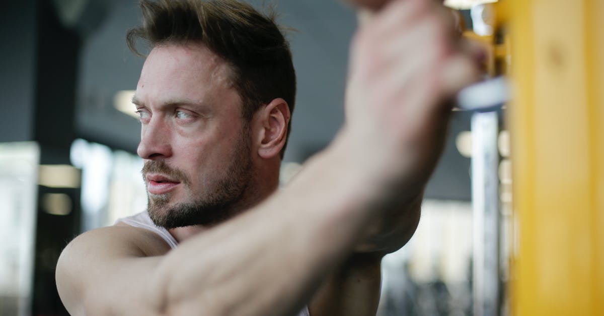Energy bar is too soft - Confident strong adult sportsman during workout in gym Energy bar is too soft - Confident strong adult sportsman during workout in gym