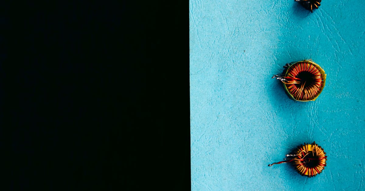 Even heating: skillet thickness vs. electric element size - Set of inductors on blue surface Even heating: skillet thickness vs. electric element size - Set of inductors on blue surface