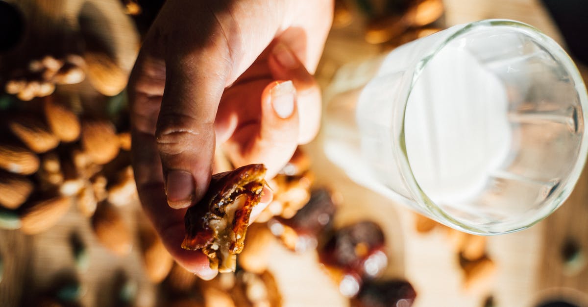 Expiration Date on Milk - A Person Holding a Date with Walnut Expiration Date on Milk - A Person Holding a Date with Walnut