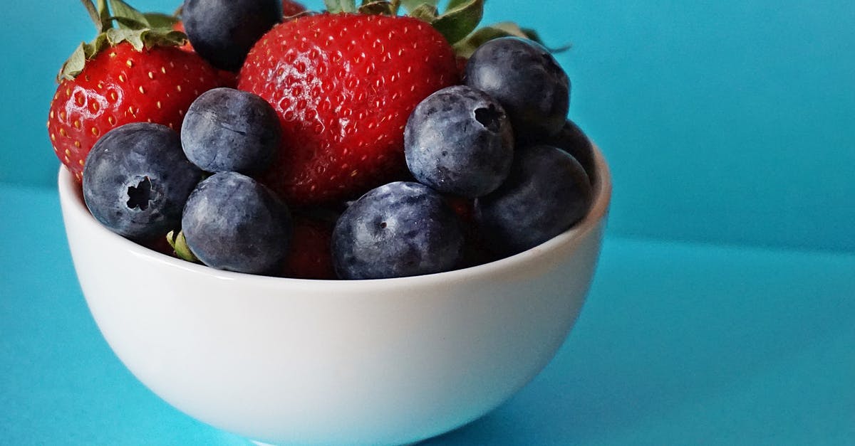Extracting colour out of strawberries - Blueberries and Strawberries in White Ceramic Bowl Extracting colour out of strawberries - Blueberries and Strawberries in White Ceramic Bowl