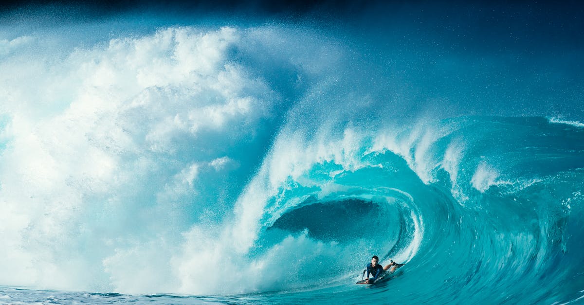 Extreme Speed Baking - Scenery of male surfer lying on surfboard and riding turquoise foamy sea waves on sunny day Extreme Speed Baking - Scenery of male surfer lying on surfboard and riding turquoise foamy sea waves on sunny day