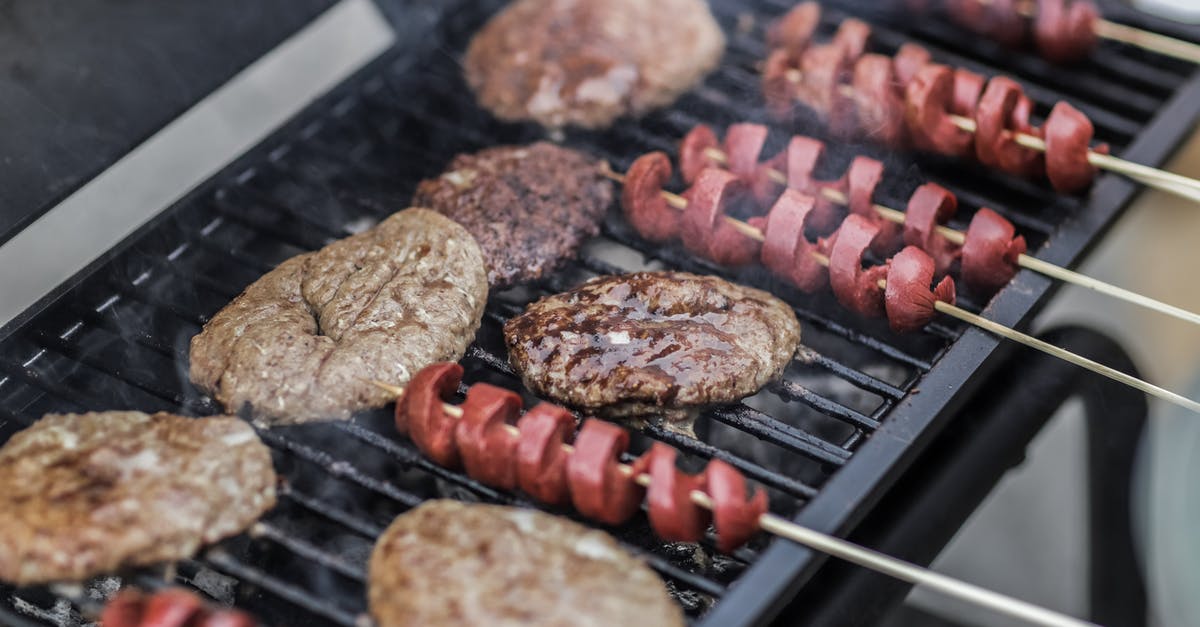 Extremely hard layer after cooking the burger on the grill - Steaks and Skewered Sausages on Grill Extremely hard layer after cooking the burger on the grill - Steaks and Skewered Sausages on Grill