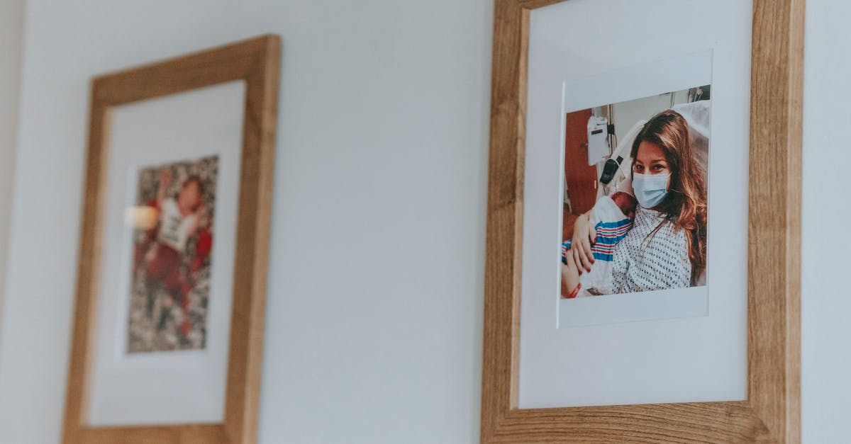 Extremely tender beef at hospital - Framed photo of young woman in medical musk hugging newborn baby while lying on bed in hospital after childbirth hanging on white wall Extremely tender beef at hospital - Framed photo of young woman in medical musk hugging newborn baby while lying on bed in hospital after childbirth hanging on white wall