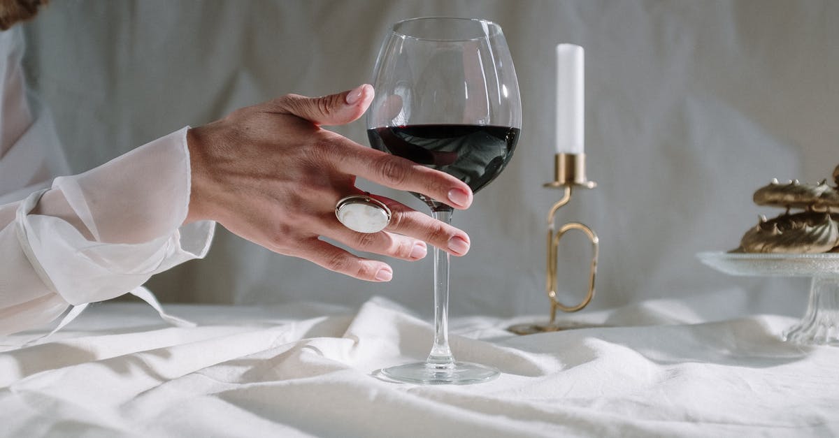 Factors affecting meringue crispness - Person Holding Clear Wine Glass