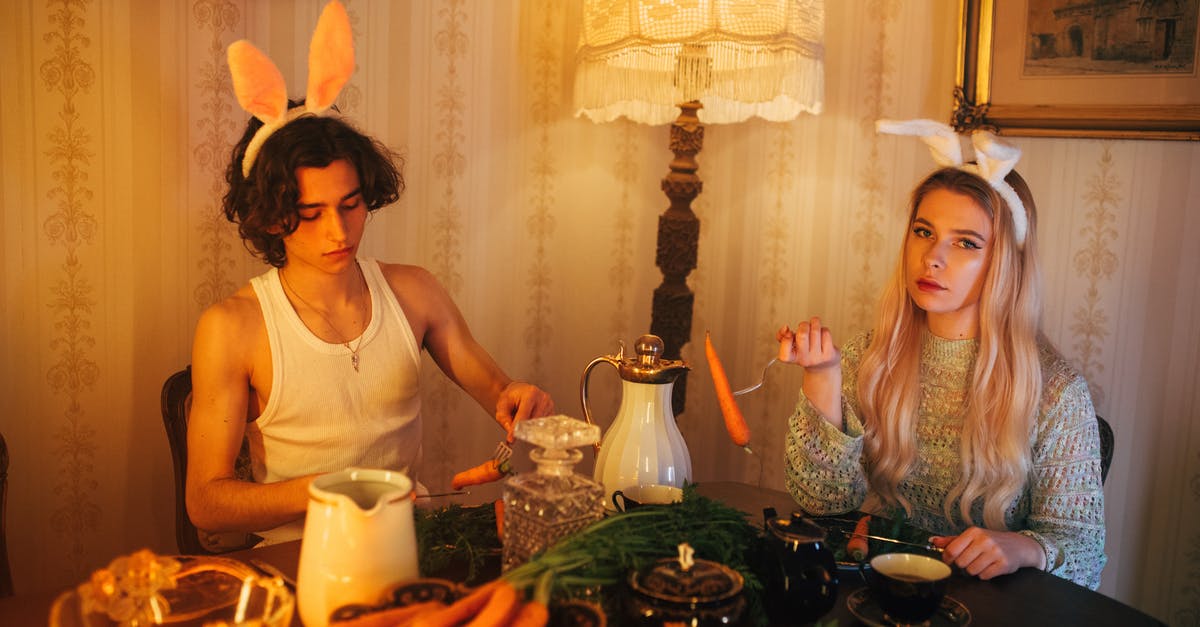 Fermented Carrots - A Boy in White Tank Top Sitting Beside the Woman in Knitted Sweater while Holding a Fork with Carrots Fermented Carrots - A Boy in White Tank Top Sitting Beside the Woman in Knitted Sweater while Holding a Fork with Carrots
