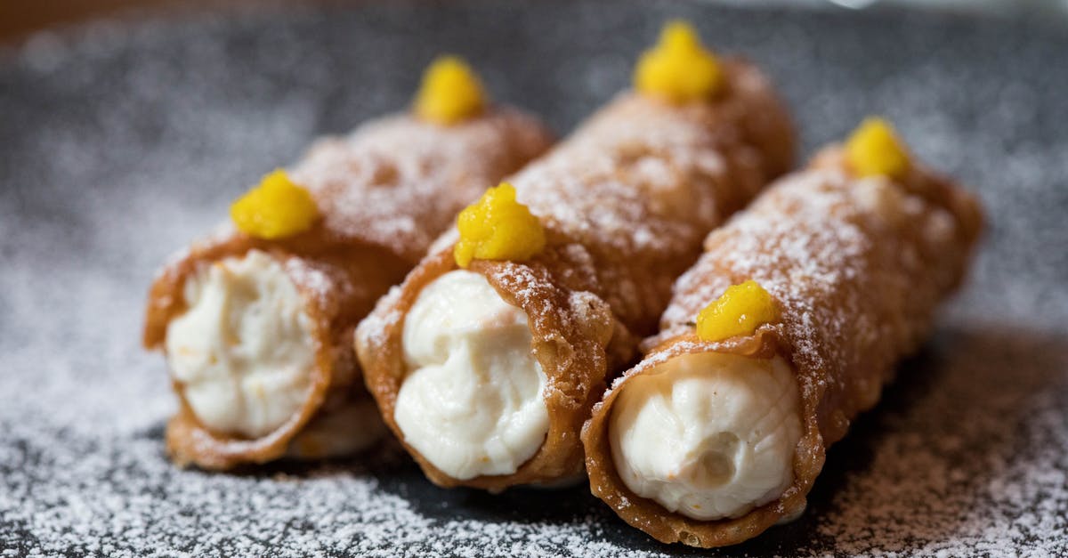 Filling vs Frosting - Yummy cannoli dessert on plate Filling vs Frosting - Yummy cannoli dessert on plate