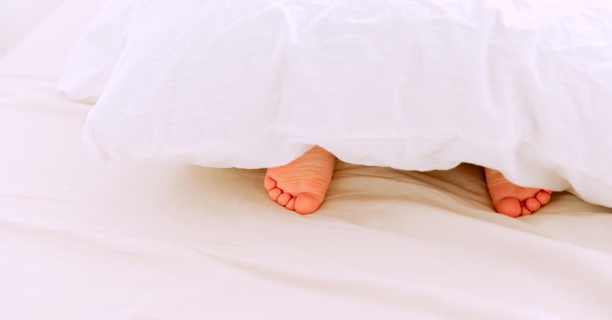 First time and small batch biryani - Crop tiny feet of little child lying under white blanket on comfortable bed in light bedroom at home First time and small batch biryani - Crop tiny feet of little child lying under white blanket on comfortable bed in light bedroom at home