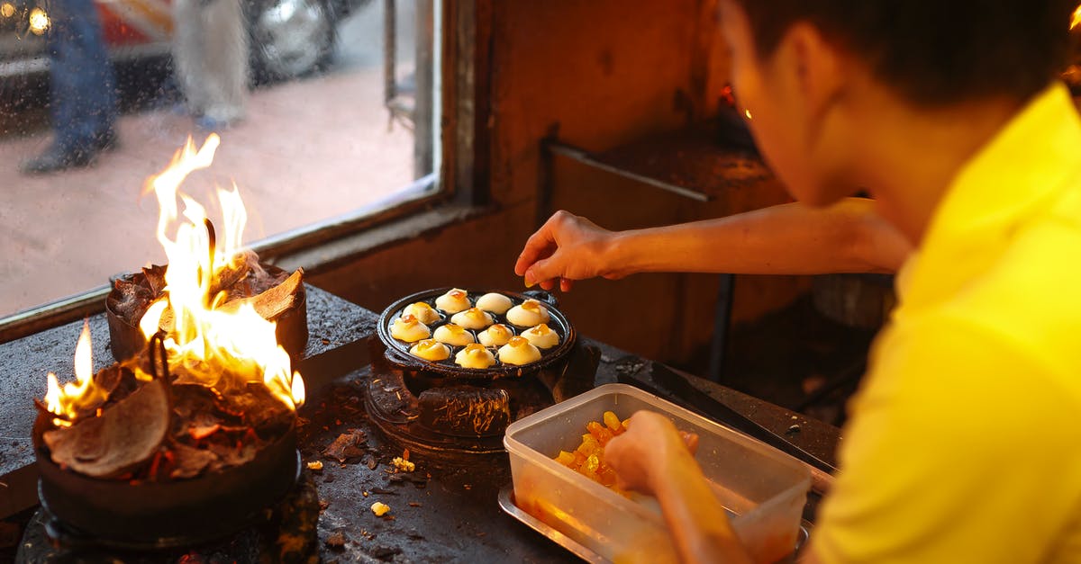 Flames into cooking area - Man Cooking Inside Kitchen Flames into cooking area - Man Cooking Inside Kitchen