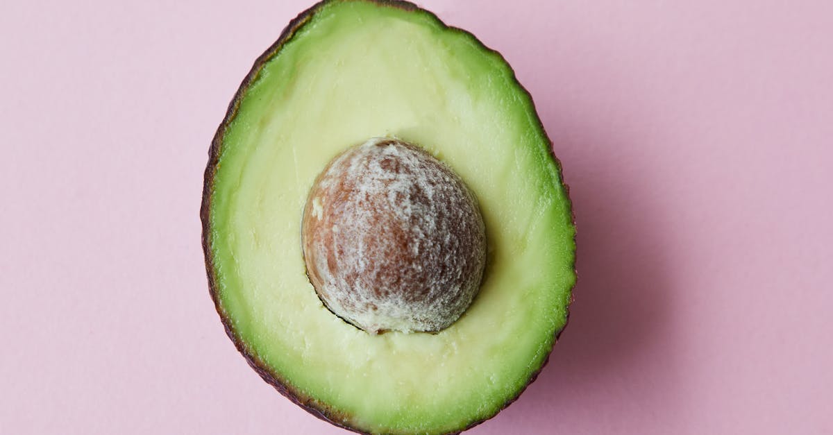 Flavor in avocadoes gone forever? - From above of half of fresh raw ripe avocado with seed on purple background Flavor in avocadoes gone forever? - From above of half of fresh raw ripe avocado with seed on purple background