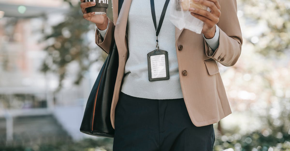 Flies in my bag of bread - bad bread? - Crop anonymous ethnic female entrepreneur with takeaway hot drink and bread walking to work