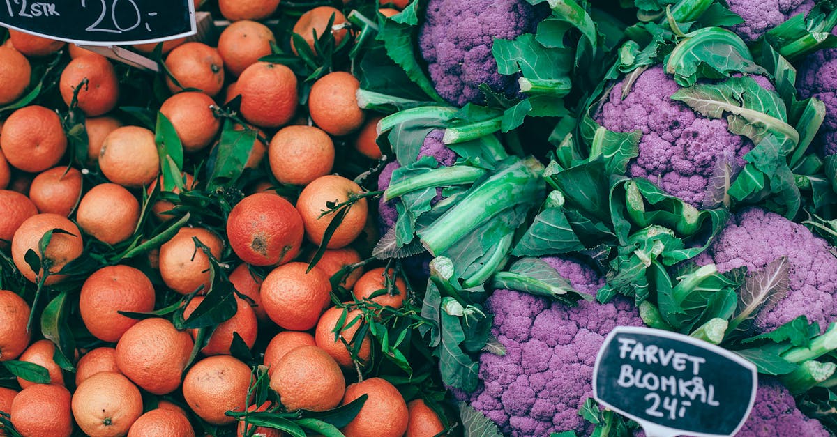 Food grade lye on counter tops - From above of fresh ripe colorful citrus fruits placed near violet healthy cauliflower on market Food grade lye on counter tops - From above of fresh ripe colorful citrus fruits placed near violet healthy cauliflower on market
