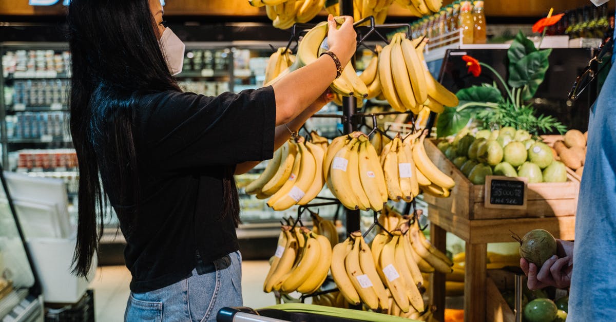 Food Safety of "Scavenged" Chicken Stock - Woman With Face Mask Holding Yellow Banana Fruit
