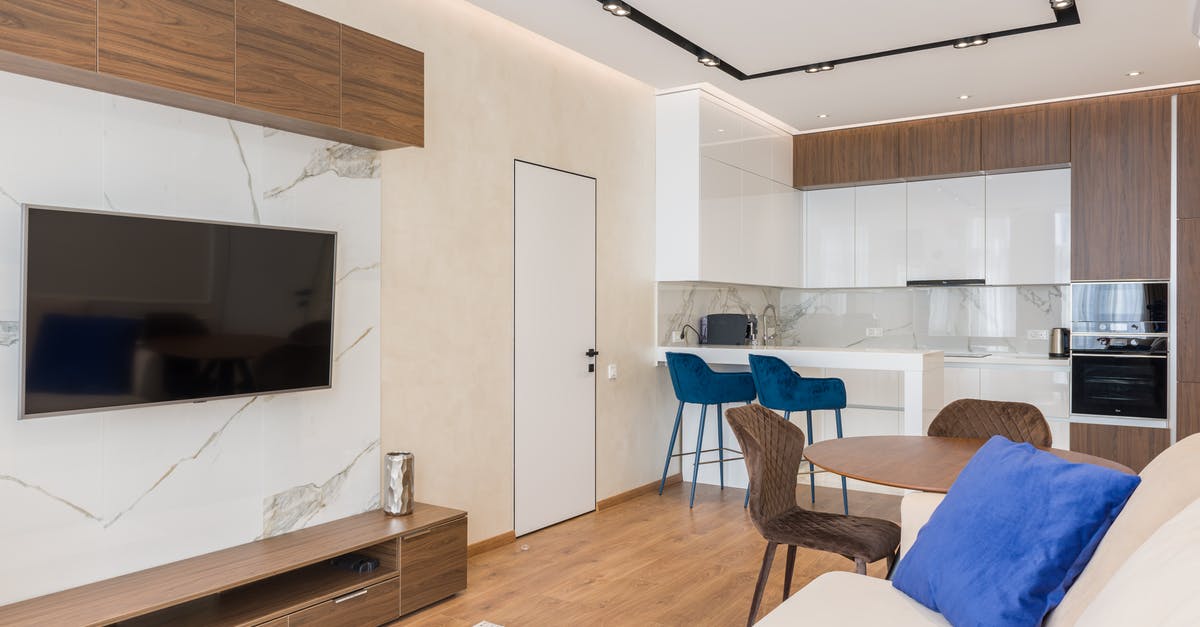 Fork left in microwave, hole in microwave wall - Interior of living room and open kitchen with comfortable sofa TV and chairs placed near round table in modern apartment Fork left in microwave, hole in microwave wall - Interior of living room and open kitchen with comfortable sofa TV and chairs placed near round table in modern apartment