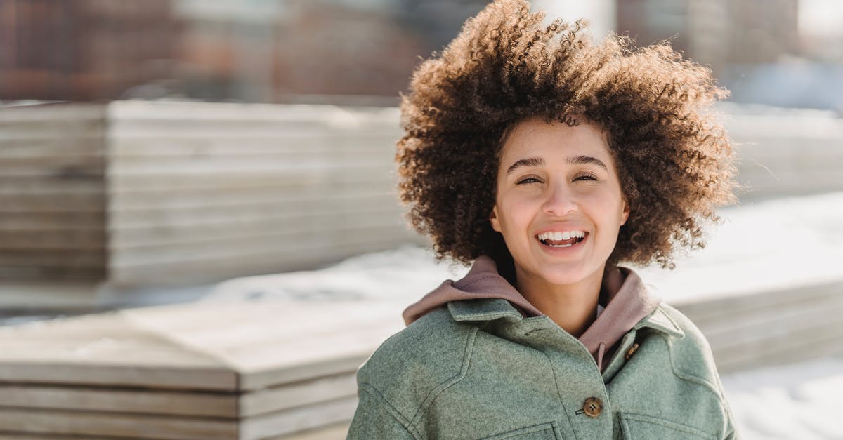Freeze friendly baked side dishes - Joyful ethnic woman standing in snowy city park Freeze friendly baked side dishes - Joyful ethnic woman standing in snowy city park
