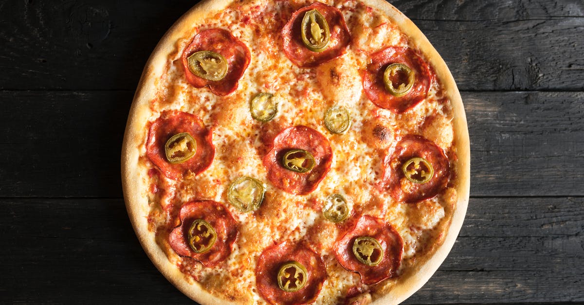 Freezing meat - whole or in pieces? - Overhead view of appetizing pizza with pepperoni and green chili pepper pieces on wooden surface Freezing meat - whole or in pieces? - Overhead view of appetizing pizza with pepperoni and green chili pepper pieces on wooden surface