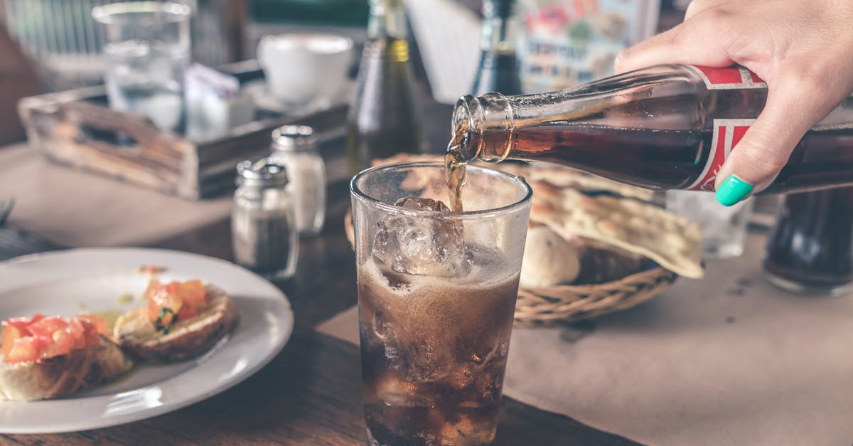 Freezing temp of carbonated beverages - Photo of Cola Pouring Into a Glass with Ice Cubes
