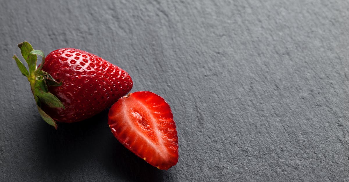 Freezing whole strawberries - Fresh Strawberries on Grey Background Freezing whole strawberries - Fresh Strawberries on Grey Background