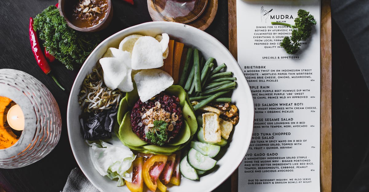 French Red Rice (Camargue) versus Italian Red Rice (Rosso Selvaggio)? - Mixed exotic salad served with sauce in summer cafe French Red Rice (Camargue) versus Italian Red Rice (Rosso Selvaggio)? - Mixed exotic salad served with sauce in summer cafe