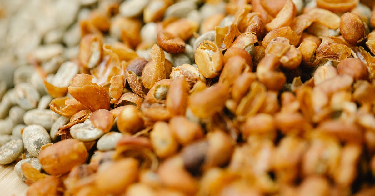Fresh half and half curdles in hot coffee - Pile of raw coffee beans drying in sun Fresh half and half curdles in hot coffee - Pile of raw coffee beans drying in sun