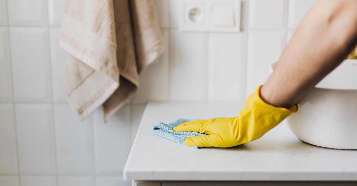 Fresh pasta work surface - Crop housewife cleaning surface near sink Fresh pasta work surface - Crop housewife cleaning surface near sink
