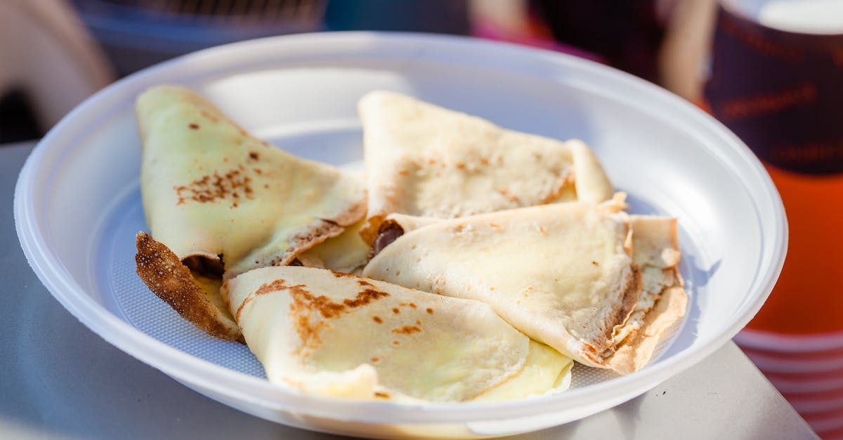 Fried pies lose their shape - Tasty hotcakes with filling in round shaped plastic plate on table in sunlight on blurred background Fried pies lose their shape - Tasty hotcakes with filling in round shaped plastic plate on table in sunlight on blurred background
