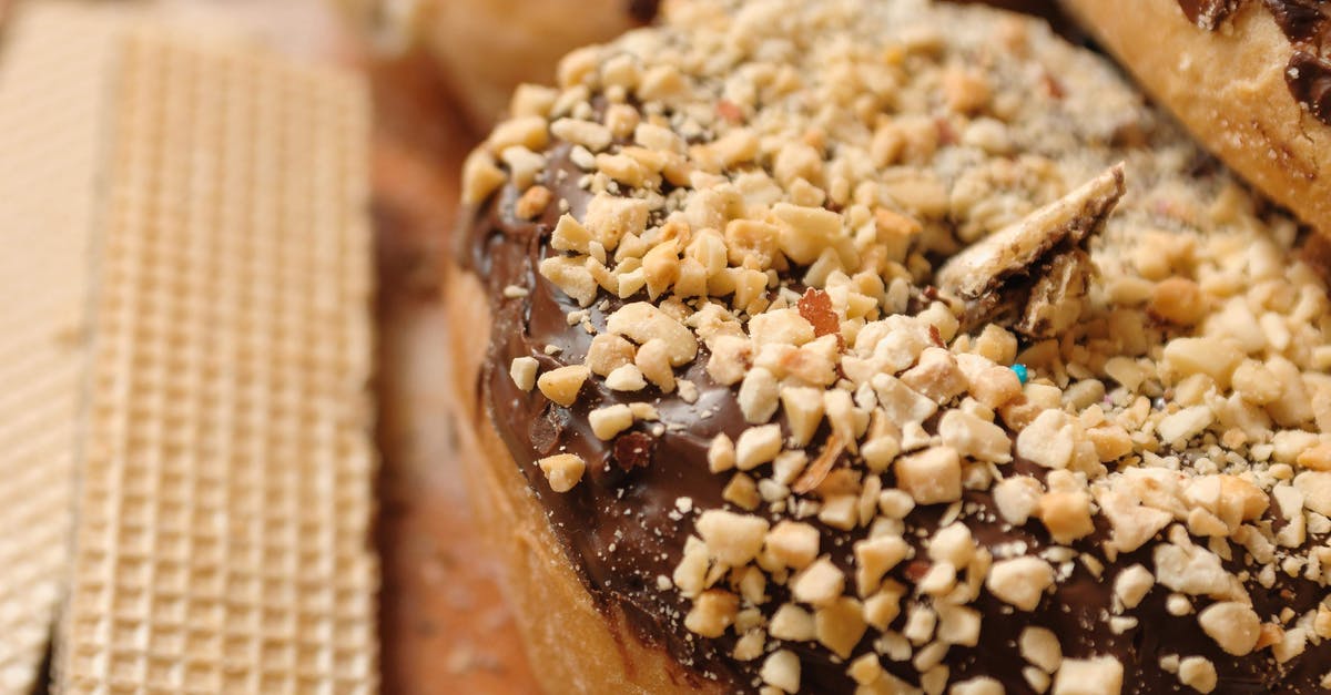 Frosting kept melting when trying to frost cake - High angle sweet donut topped with chocolate frosting and chopped nuts placed near waffles on board Frosting kept melting when trying to frost cake - High angle sweet donut topped with chocolate frosting and chopped nuts placed near waffles on board