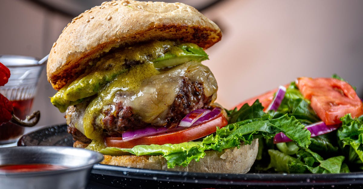 Frozen raw beef patties vs cooked refrigerated patties? - Burger With Lettuce and Tomato on Black Ceramic Plate Frozen raw beef patties vs cooked refrigerated patties? - Burger With Lettuce and Tomato on Black Ceramic Plate