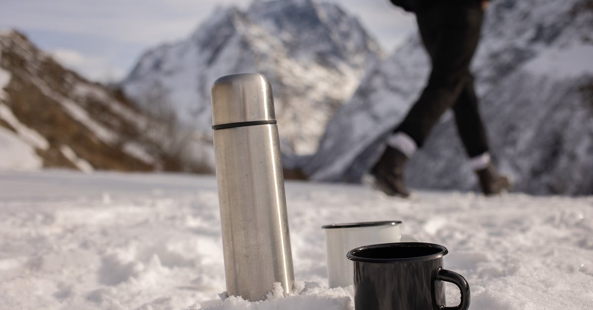 Frozen scallops - Thermos Near Ceramic Mugs on Snow Covered Ground Frozen scallops - Thermos Near Ceramic Mugs on Snow Covered Ground