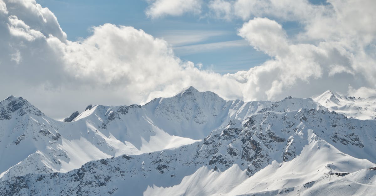 Frozen scallops - Snow Covered Mountain Under White Clouds and Blue Sky Frozen scallops - Snow Covered Mountain Under White Clouds and Blue Sky