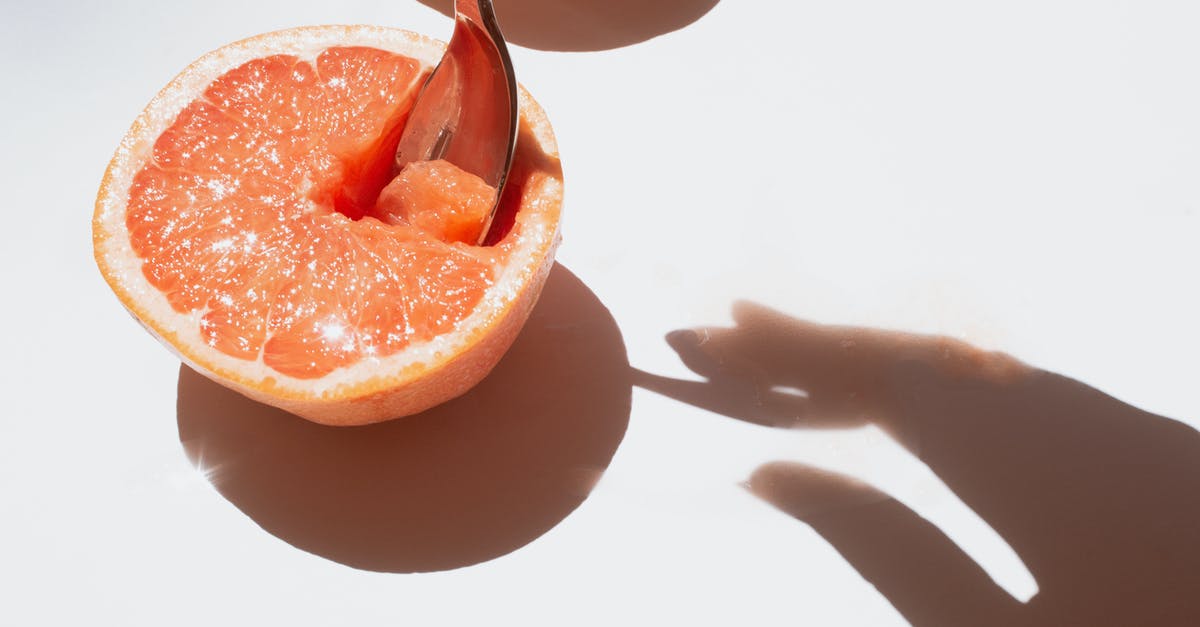 Fruit Flies and Storage of Fresh Produce - Sliced Grapefruit Fruit on White Surface Fruit Flies and Storage of Fresh Produce - Sliced Grapefruit Fruit on White Surface